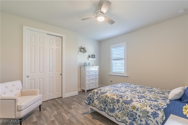 bedroom featuring ceiling fan, light hardwood / wood-style flooring, and a closet