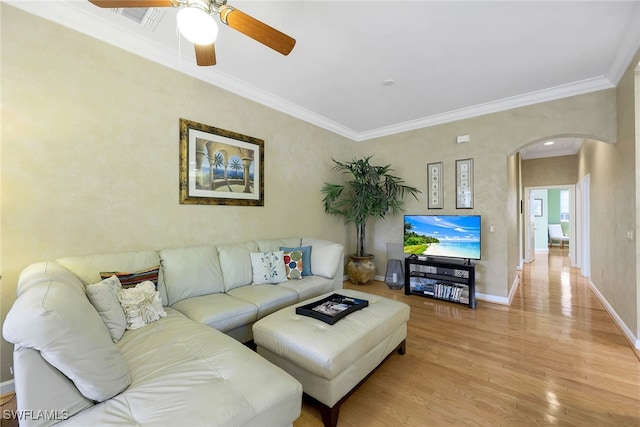 living room with light hardwood / wood-style floors, ceiling fan, and ornamental molding