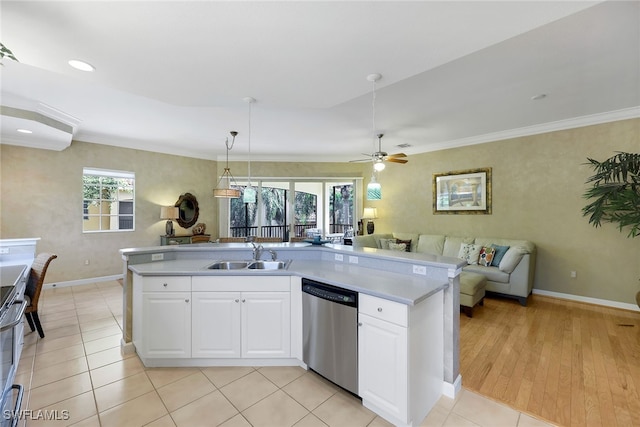 kitchen with stainless steel dishwasher, sink, white cabinets, light hardwood / wood-style floors, and plenty of natural light