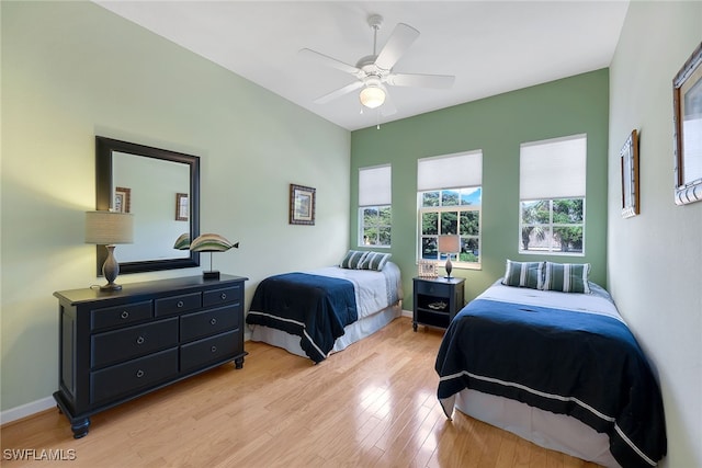 bedroom with ceiling fan and light wood-type flooring