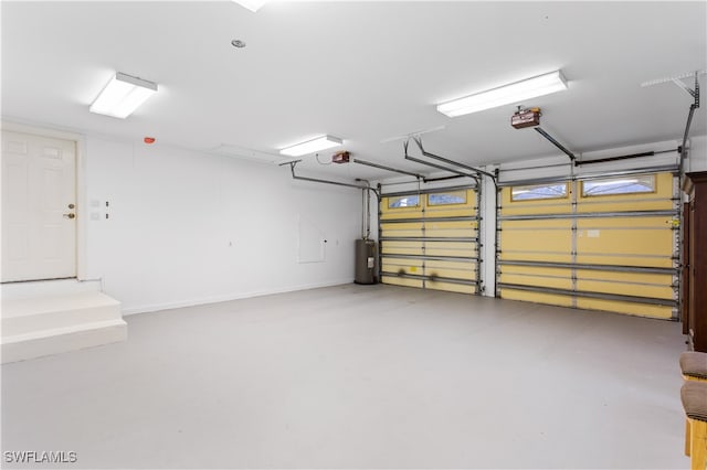 garage featuring electric water heater and a garage door opener