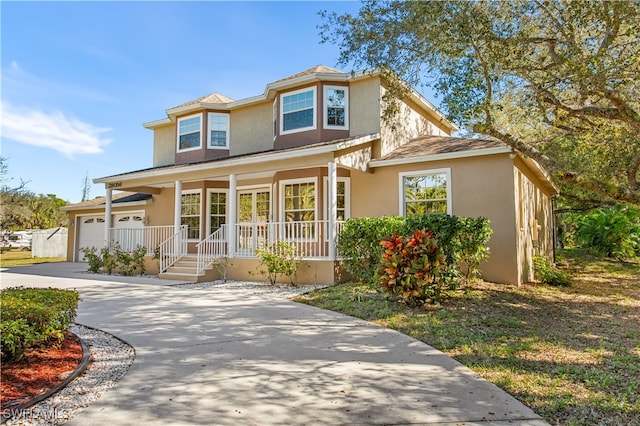 view of front of property with a garage and covered porch