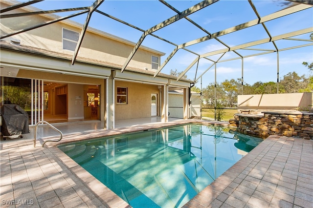 view of pool featuring a patio area and a lanai