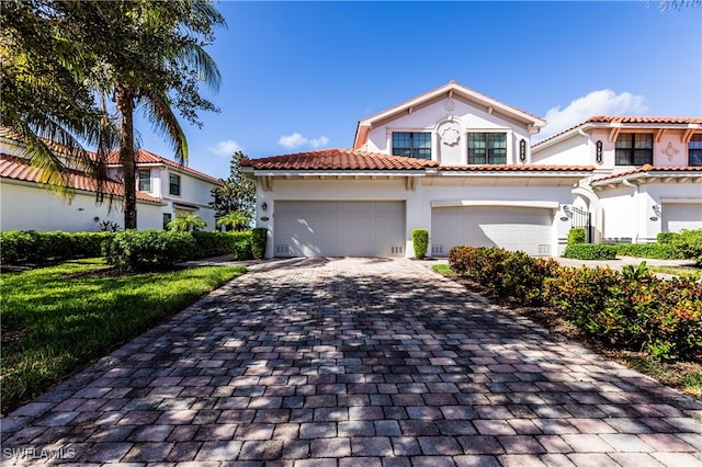 mediterranean / spanish house with a garage