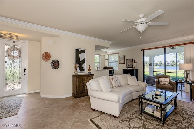 tiled living room with a wealth of natural light, crown molding, and ceiling fan