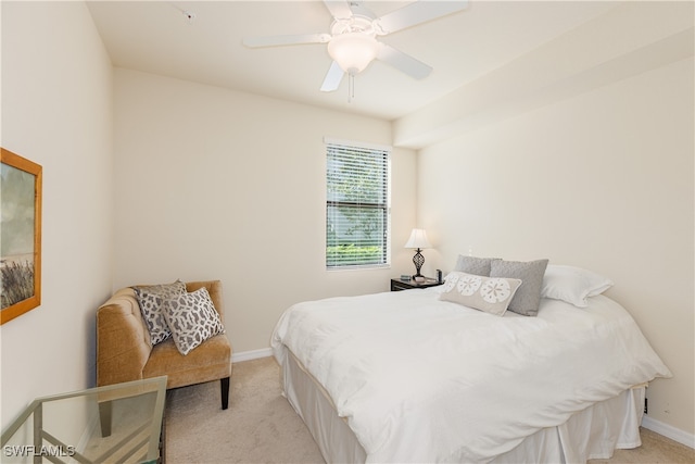 bedroom with ceiling fan and light carpet