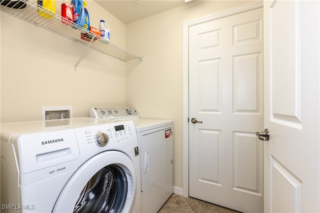 laundry room with independent washer and dryer and light tile patterned flooring