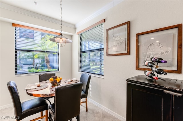 tiled dining area featuring crown molding