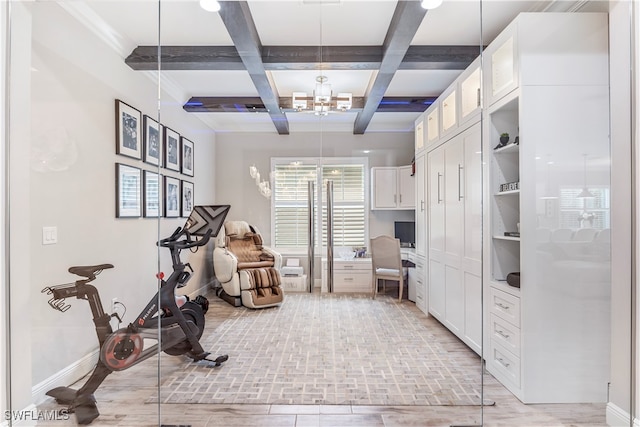 interior space with light hardwood / wood-style floors, built in desk, and coffered ceiling