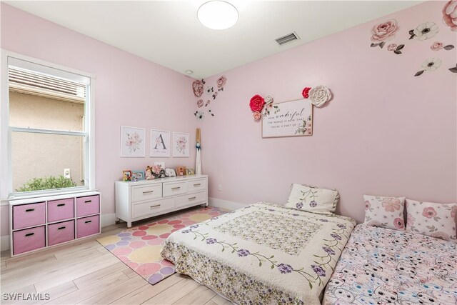 bedroom with light hardwood / wood-style flooring