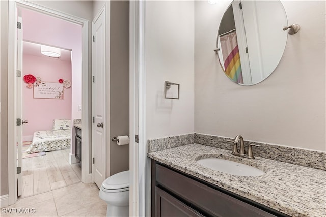 bathroom with vanity, wood-type flooring, and toilet