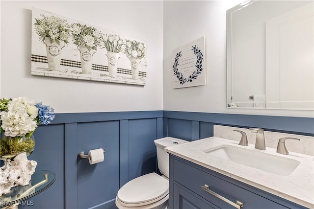 bathroom featuring vanity and toilet