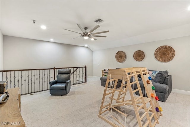 living area with ceiling fan and light carpet