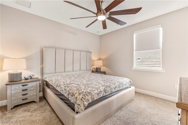 bedroom with ceiling fan and light carpet