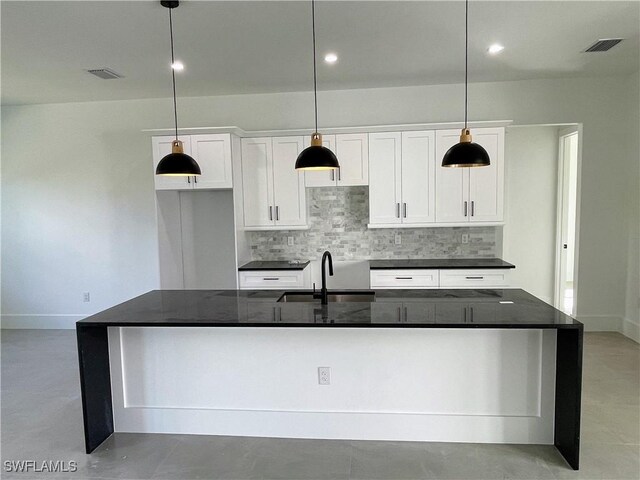 442 4th St SE, Naples, FL 34117 - kitchen featuring a sink, tasteful backsplash, white cabinets, a kitchen island with sink, and recessed lighting