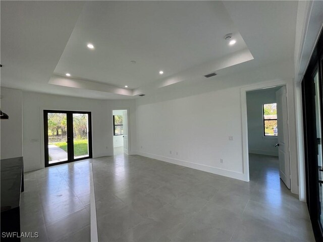 442 4th St SE, Naples, FL 34117 - empty room with a raised ceiling, plenty of natural light, recessed lighting, and baseboards