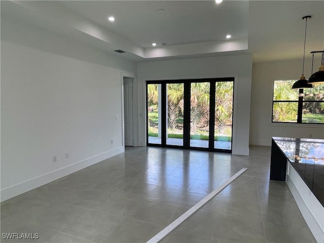 442 4th St SE, Naples, FL 34117 - spare room with baseboards, recessed lighting, and a tray ceiling