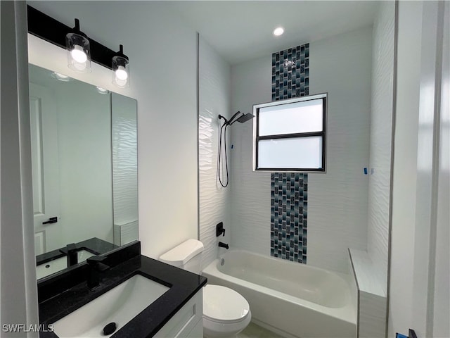 full bathroom with tiled shower / bath, toilet, and vanity