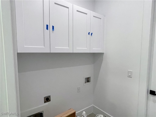 laundry room with hookup for an electric dryer, washer hookup, and cabinets