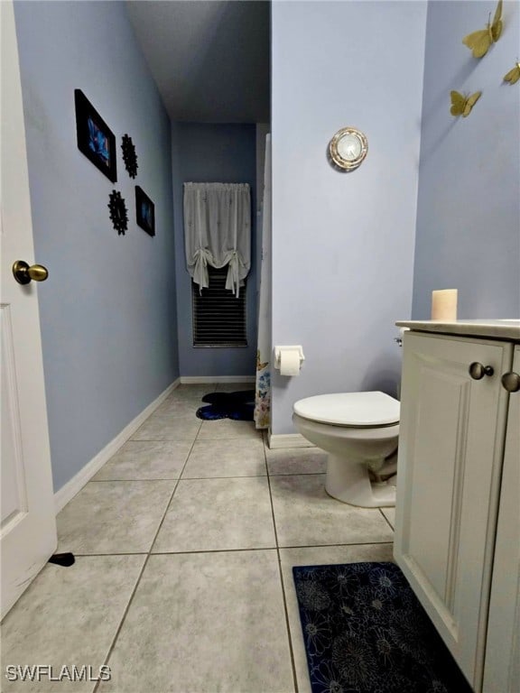 bathroom with tile patterned flooring, vanity, and toilet