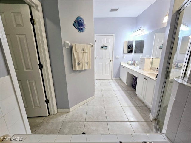 bathroom with vanity, tile patterned floors, and a shower with door