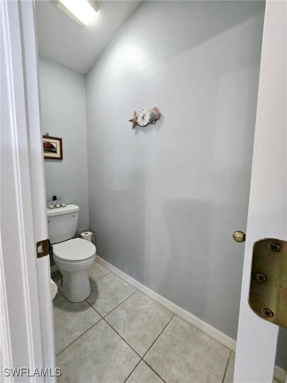 bathroom with toilet and tile patterned floors