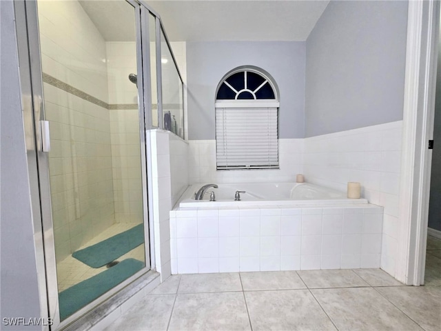 bathroom featuring tile patterned flooring and shower with separate bathtub