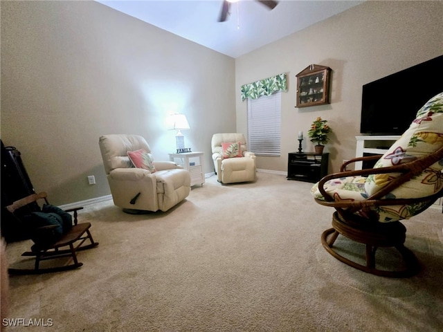 living area featuring carpet and ceiling fan