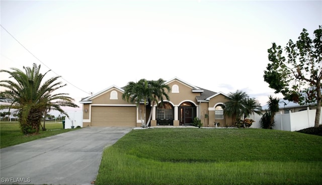 view of front facade with a garage and a front lawn