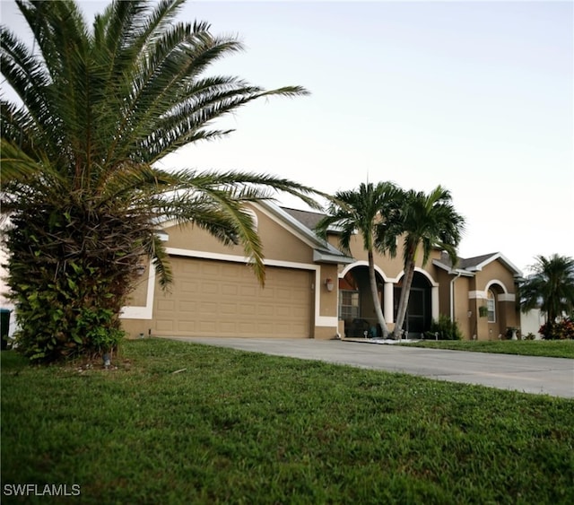 view of front of property featuring a garage and a front yard