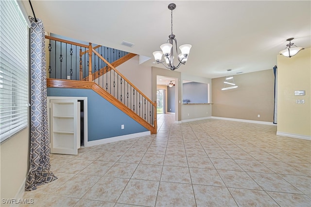 unfurnished living room featuring light tile patterned floors and an inviting chandelier