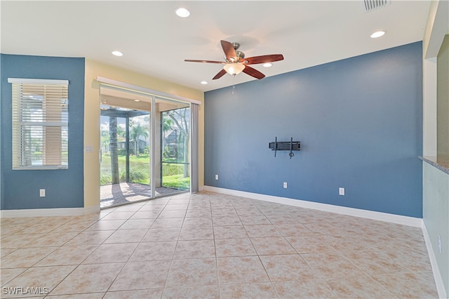 spare room featuring ceiling fan and light tile patterned floors