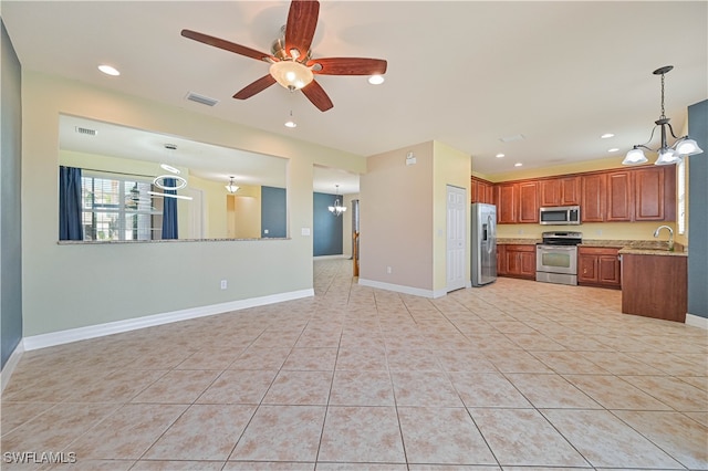 kitchen with sink, decorative light fixtures, light tile patterned floors, ceiling fan with notable chandelier, and appliances with stainless steel finishes