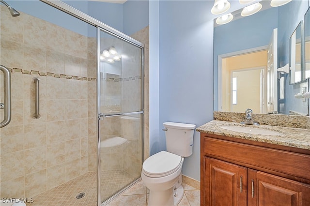 bathroom with walk in shower, tile patterned floors, vanity, and toilet