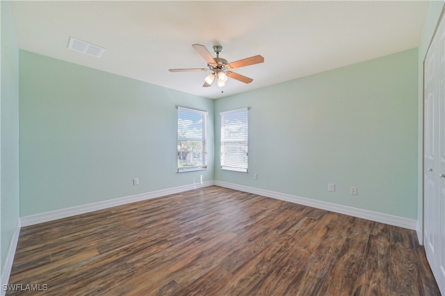 empty room featuring ceiling fan and dark hardwood / wood-style flooring