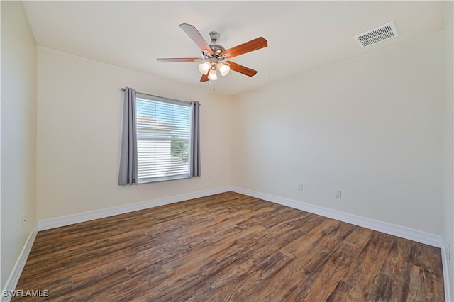 spare room featuring ceiling fan and dark hardwood / wood-style flooring