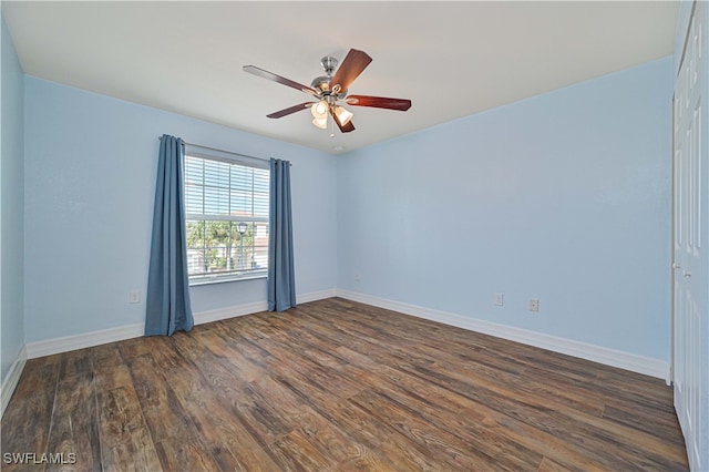 empty room featuring ceiling fan and dark wood-type flooring