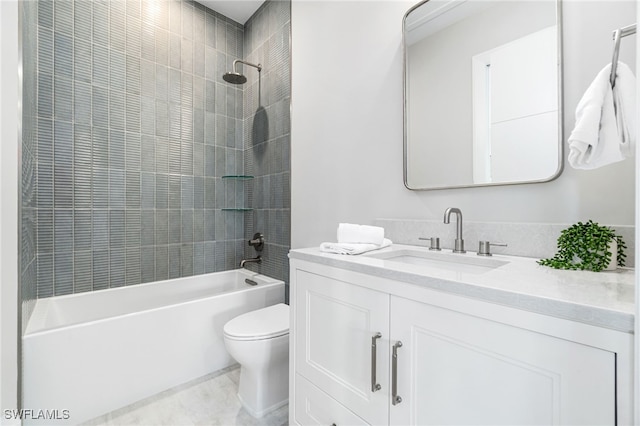 full bathroom featuring tiled shower / bath combo, toilet, and vanity