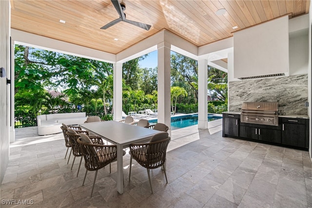 view of patio / terrace with area for grilling, ceiling fan, and an outdoor kitchen