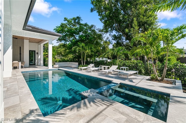 view of swimming pool featuring outdoor lounge area, an in ground hot tub, and a patio