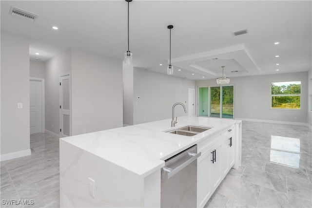 kitchen featuring dishwasher, a kitchen island with sink, hanging light fixtures, and sink