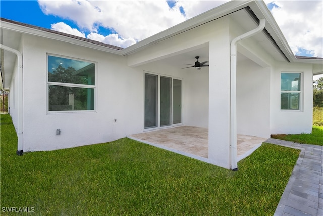 back of house with a patio area, a yard, and ceiling fan