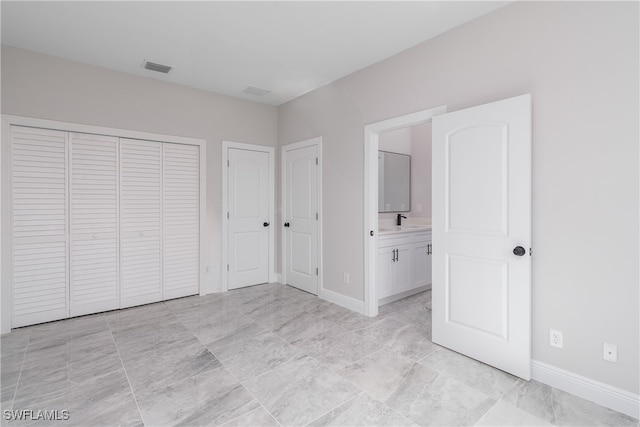 unfurnished bedroom featuring ensuite bath