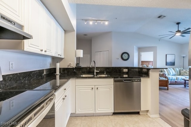 kitchen featuring lofted ceiling, sink, kitchen peninsula, white cabinetry, and stainless steel appliances