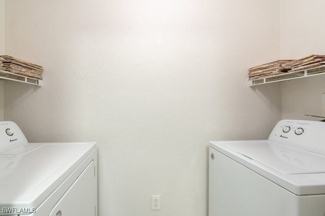 clothes washing area featuring washing machine and clothes dryer