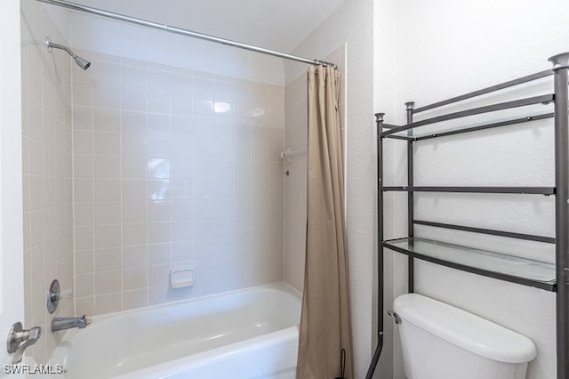 bathroom featuring toilet and shower / tub combo with curtain