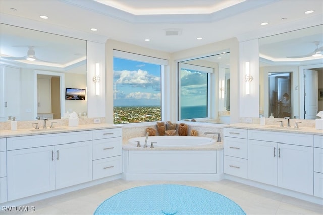 bathroom with tile patterned flooring, vanity, crown molding, and a tray ceiling