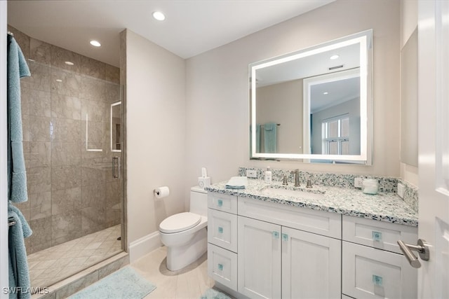 bathroom with tile patterned floors, vanity, a shower with shower door, and toilet