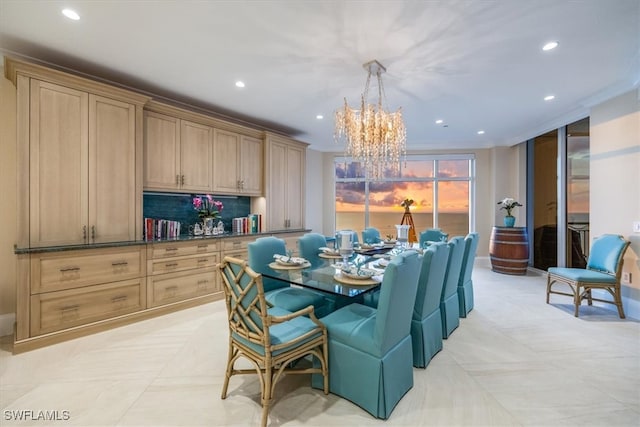 dining room featuring crown molding, light tile patterned floors, and a chandelier