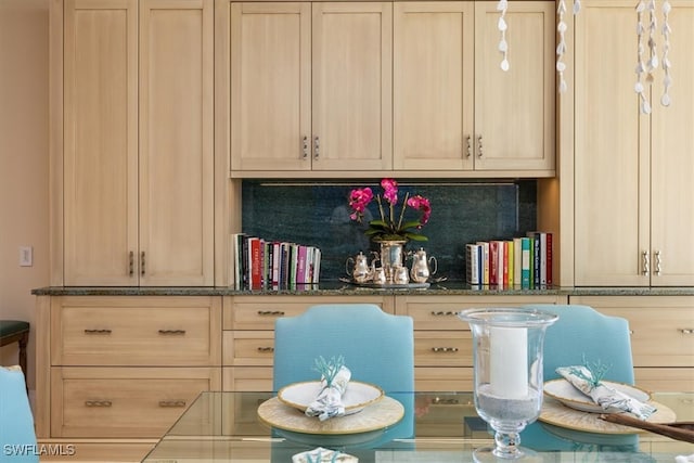 interior space with decorative backsplash and light brown cabinetry